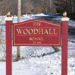 A two sided carved gold leaf sign mounted between two posts for a school in Bethlehem